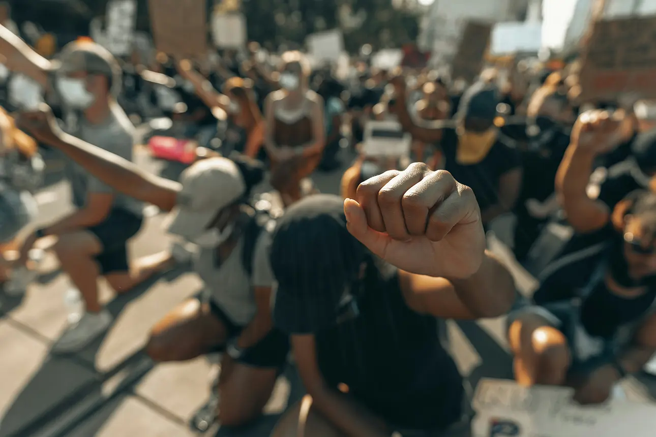 Protesters holding justice signs at a rally